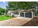 Charming home with two-car garage, manicured lawn, and a white porch at 3833 Paddington Trail, Rex, GA 30273