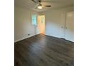 Bedroom featuring a ceiling fan, neutral paint, two large closets, and new flooring at 4706 Piney Grove Rd, Cumming, GA 30040