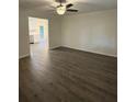 Bright living room with new flooring, neutral paint and ceiling fan fixture at 4706 Piney Grove Rd, Cumming, GA 30040