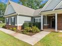 Close-up view of the attractive landscaping around the walkway leading to the front door at 110 Collingwood Lndg, Covington, GA 30016