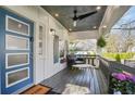 Relaxing front porch featuring a ceiling fan, seating, and a decorative multi-light front door at 1766 Ware Ave, Atlanta, GA 30344