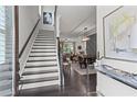 Elegant foyer features staircase with hardwood floors and decorative lighting at 205 Maplewood Dr, Roswell, GA 30075
