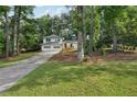 Charming two-story home with white siding, a two-car garage, and a luscious lawn at 4363 Old Mabry Road Northeast Ne Rd, Roswell, GA 30075