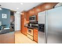 Well-equipped kitchen features stainless steel appliances, modern wood cabinetry, and ample counter space at 943 Peachtree Ne St # 902, Atlanta, GA 30309