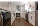 Bright kitchen featuring white cabinets, stainless steel appliances, and hardwood floors at 3480 Tanbark Ne Ct, Brookhaven, GA 30319