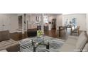 Modern open-concept living room with dark wood flooring, stainless steel appliances and stairs to the second floor at 3480 Tanbark Ne Ct, Brookhaven, GA 30319