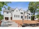Elegant white brick home with black windows and a three-car garage at 3118 Lanier Ne Dr, Brookhaven, GA 30319