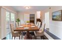 Elegant dining room featuring a large wooden table with seating for six and sliding glass doors at 6708 Bedford Rd, Rex, GA 30273