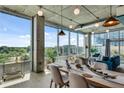 Open-concept living and dining area with industrial-chic design and city skyline views at 943 Peachtree Ne St # 814, Atlanta, GA 30309