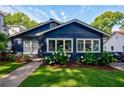 Attractive blue home with lush green lawn and white flower bushes enhancing curb appeal at 1190 Francis Nw St, Atlanta, GA 30318