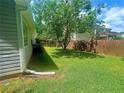 View of back of home showing fence and lush green lawn with trees at 148 Parkside Dr, Stockbridge, GA 30281