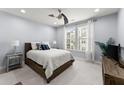 This bedroom has a large bed, a ceiling fan, and large windows with plenty of natural light at 901 Abernathy Ne Rd # 5140, Sandy Springs, GA 30328