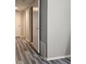 Hallway with wood-look floors, white doors, and neutral wall color with light fixtures at 108 Countryside Se Pl, Smyrna, GA 30080