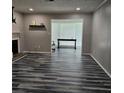 Spacious living room with wood-look floors, a fireplace, and a large opening to an adjacent room at 108 Countryside Se Pl, Smyrna, GA 30080
