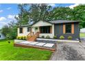 Landscaped single-story home with a lush lawn, and contemporary exterior paint at 1326 Stella Sw Cir, Mableton, GA 30126