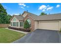 This home features a well-maintained lawn, attached garage, and beautiful shrubbery along the front of the house at 1402 Silver Summit Se Dr, Conyers, GA 30094