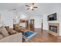 Open-concept living room with vaulted ceiling, a fireplace, and hardwood floors for seamless entertaining and relaxation at 1402 Silver Summit Se Dr, Conyers, GA 30094