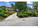 Long driveway leading to a traditional brick home surrounded by lush greenery at 3013 Huntshire, Doraville, GA 30340