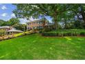 Sprawling front lawn and mature trees create a beautiful setting for this brick home at 3013 Huntshire, Doraville, GA 30340