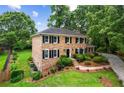 Well-maintained brick home with manicured lawn and mature trees at 3013 Huntshire, Doraville, GA 30340