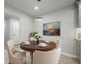 Bright dining area featuring a round wood table set for four with stylish modern chandelier at 3160 Ann Se Rd, Smyrna, GA 30080