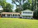 Well-maintained home featuring classic architecture and a lush green lawn, perfect for outdoor activities at 4798 Mary Dale Ct, Lilburn, GA 30047