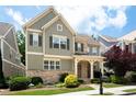 Charming two-story home boasts a stone and siding exterior with a welcoming front porch and landscaped yard at 238 Avery Ne St, Marietta, GA 30060
