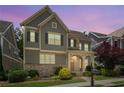 Charming two-story home boasts a stone and siding exterior with a welcoming front porch and landscaped yard at 238 Avery Ne St, Marietta, GA 30060