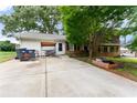 Exterior shot of a house with a spacious concrete backyard and a charming porch swing at 2711 Bethesda Ne Ct, Lawrenceville, GA 30044