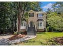 Charming two-story brick home with bay windows, fresh landscaping, and a welcoming staircase at 3440 Oaktree Way, Stonecrest, GA 30038