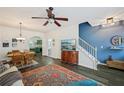 Bright living area featuring a decorative rug, hardwood floors, and a modern staircase at 2084 Del Lago Nw Cir # 1, Kennesaw, GA 30152