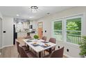 Bright kitchen with white cabinets, granite countertops, black appliances, and stylish luxury vinyl plank flooring at 5160 W Chapel Hill Rd, Douglasville, GA 30135