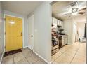 View of entryway with yellow door leading into kitchen with stainless steel appliances and tile flooring at 5273 Martins Crossing Rd, Stone Mountain, GA 30088