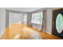 Inviting living room with gleaming hardwood floors, neutral paint, and large windows offering natural light at 2473 Melinda Ne Dr, Atlanta, GA 30345