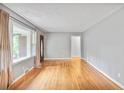 Bright living room with neutral walls, hardwood floors, and natural light from the large front window at 2473 Melinda Ne Dr, Atlanta, GA 30345