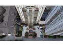 Stunning aerial view of the high-rise condo building showcasing the entrance, landscaping, and surrounding buildings at 795 Hammond Dr # 506, Sandy Springs, GA 30328