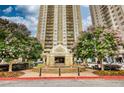 Elegant high-rise apartment building featuring manicured landscaping and a welcoming entrance fountain at 795 Hammond Dr # 506, Sandy Springs, GA 30328