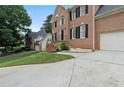 The exterior of this brick home features a well-maintained lawn, brick steps, and a side-entry garage at 2167 Merrymount Dr, Suwanee, GA 30024