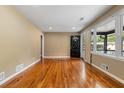 Spacious living room featuring hardwood floors, neutral walls, and a view of the front porch at 2266 Kennedy Nw Ct, Atlanta, GA 30318