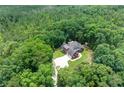 Stunning aerial view showcases house surrounded by lush, mature trees, and expansive lawns at 6020 Cochran Mill Rd, Palmetto, GA 30268