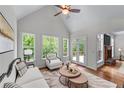 Sun-filled living room boasts hardwood floors, white walls, and windows overlooking mature trees at 6020 Cochran Mill Rd, Palmetto, GA 30268