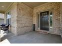 Covered front porch with brick columns and tile flooring, ideal for outdoor seating at 622 Denali Dr, Mableton, GA 30126