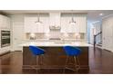 Modern kitchen with island, white cabinets, stainless steel appliances, and pendant lighting at 622 Denali Dr, Mableton, GA 30126