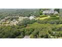 Aerial view of a community lake surrounded by lush greenery and residential houses at 3561 Stone Dr, Marietta, GA 30062
