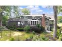 Expansive backyard featuring a deck, lush landscaping, and ample space for outdoor activities at 3561 Stone Dr, Marietta, GA 30062
