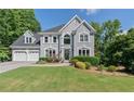 Elegant gray two-story home with a well-maintained lawn and mature trees at 681 Braidwood Nw Ter, Acworth, GA 30101