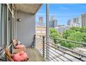 Private balcony includes seating, a view of the city, and wrought iron railings at 171 Auburn Ne Ave # 521, Atlanta, GA 30303