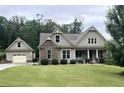 Beautiful house with stone accents, attached garage, well-manicured lawn, and lovely landscaping at 37 Grand Georgian Ne Ct, Cartersville, GA 30121
