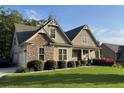 Attractive home with a stone-accented facade, well-kept lawn, and an attached garage at 37 Grand Georgian Ne Ct, Cartersville, GA 30121
