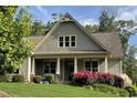Inviting home featuring a covered porch, tidy landscaping, and flowering shrubs at 37 Grand Georgian Ne Ct, Cartersville, GA 30121